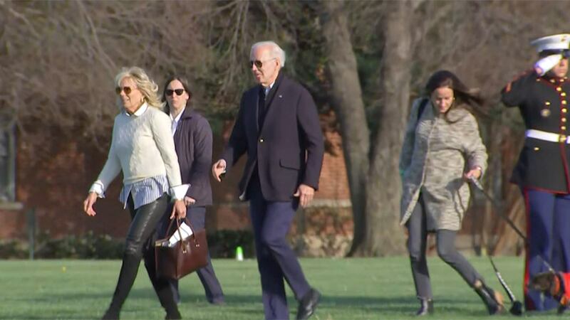 Shown with first lady Dr. Jill Biden, President Joe Biden arrives at the White House in this...