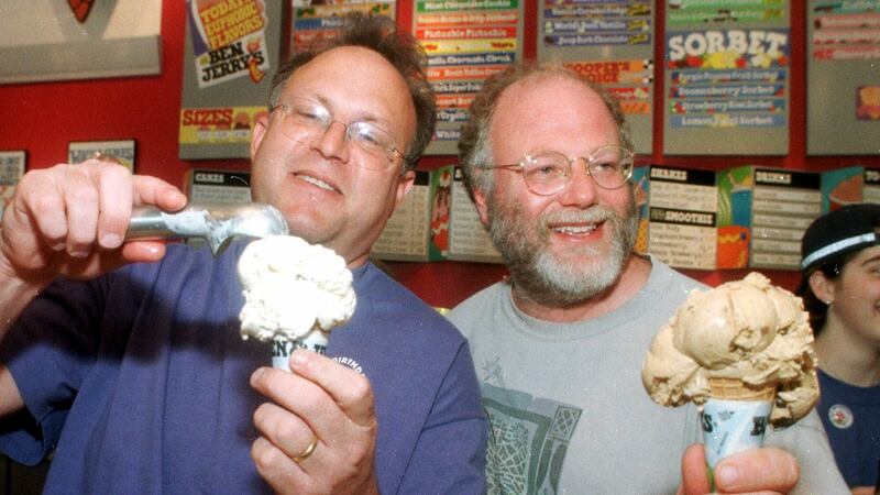 Jerry Greenfield, left, and Ben Cohen scoop ice cream cones during their 20th anniversary...