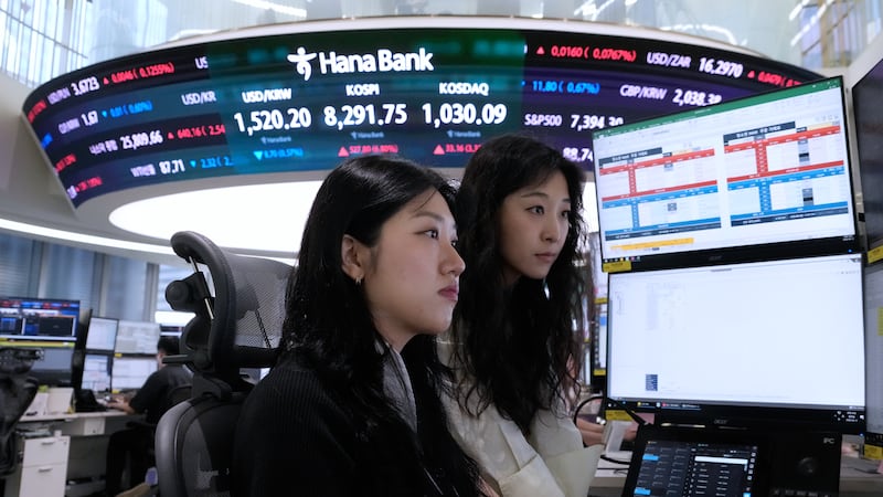 Currency traders watch monitors at the foreign exchange dealing room of the Hana Bank...