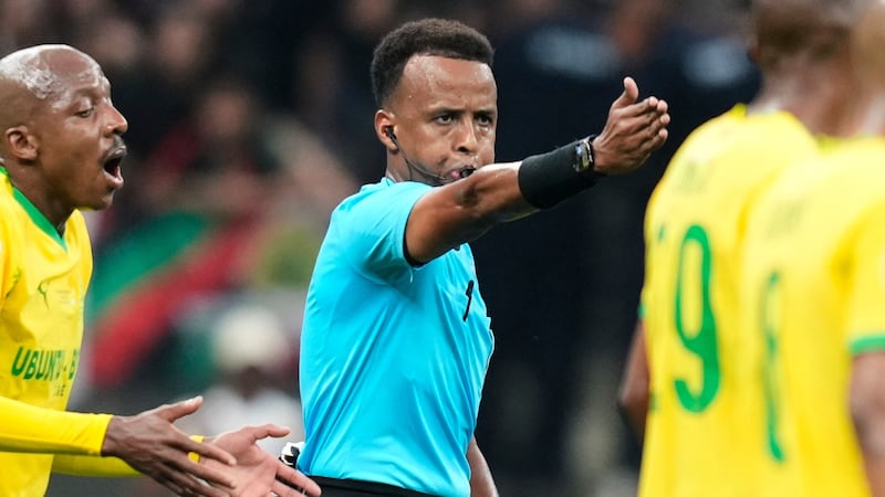FILE - Referee Omar Artan, center, signals a penalty during the CAF Champions League final...