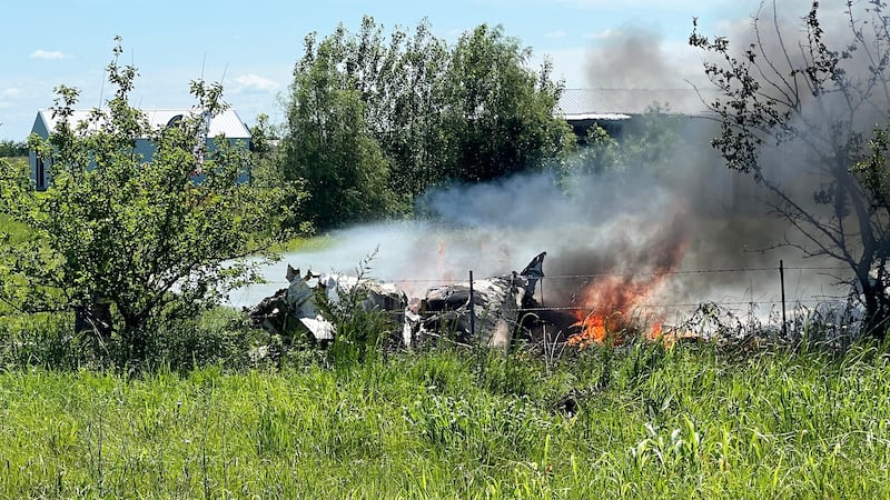 The wreckage of a plane crash burns in a field in Butler, Mo, Sunday, June 14, 2026. (Mid...