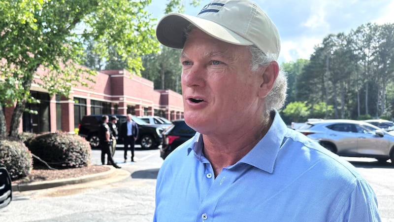 U.S. Rep Mike Collins campaigns in Woodstock, Ga., Sunday, June 14, 2026. ( AP Photo/Bill Barrow)