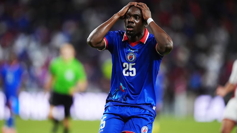 Haiti midfielder Dominique Simon reacts following an unsuccessful scoring attempt during the...