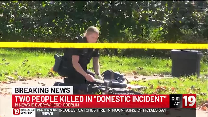 An Ohio college professor and a woman were found shot to death in a home, and a suspect is in...